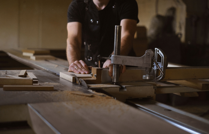 Cabinetmaker cutting a timber panel in a workshop